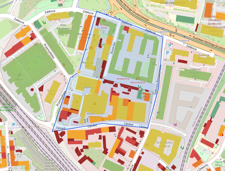 Kolorowa mapa obszaru z niebieską obwódką granic, czerwonymi budynkami i strefami funkcjonalnymi oraz opisami ulic Lipowa i Zabłocie.